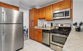 Washington apartment for rent - a kitchen with stainless steel appliances and wooden cabinets