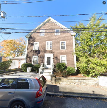 Marblehead apartment for rent - an old brick house with a car parked in front of it