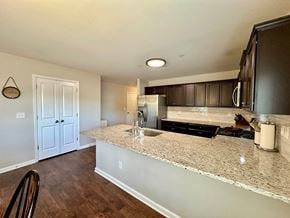Piedmont house for rent - a kitchen with a granite counter top and a stainless steel refrigerator