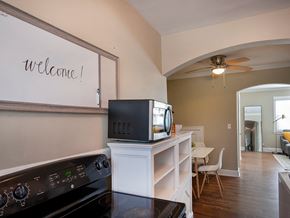 Greenville house for rent - a kitchen with a television on top of a cabinet