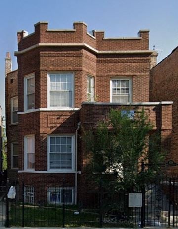 Chicago apartment for rent - a red brick house with a tree in front of it