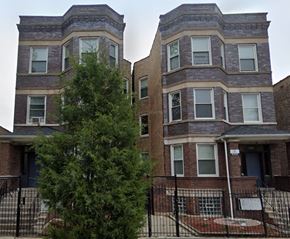 Chicago apartment for rent - A tree is in front of a two-story brick building.