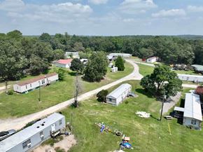 Milledgeville apartment for rent - A bird's eye view of a residential area with houses and trees.