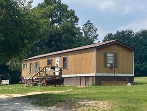Milledgeville apartment for rent - A wooden house with a porch and a covered patio.