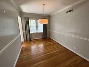 Atlanta house for rent - A room with wooden floors and a window with curtains.