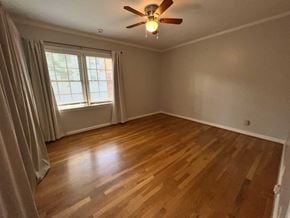 Atlanta house for rent - A room with a ceiling fan and wooden flooring.