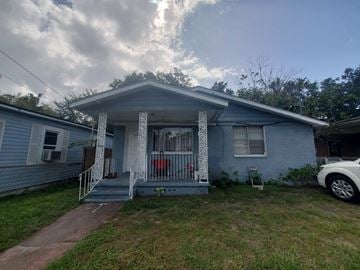 Jacksonville house for rent - a blue house with a porch and a car parked in front of it