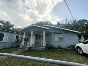 Jacksonville house for rent - a blue house with a white car parked in front of it
