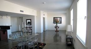 Louisville apartment for rent - a view of a living room with a glass table and chairs
