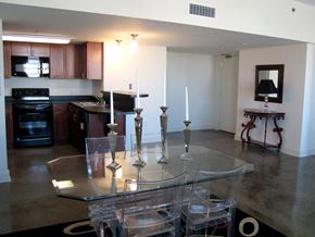 Louisville apartment for rent - an open kitchen and dining room with a glass table and chairs