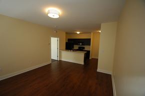 Louisville apartment for rent - an empty living room with wood floors and a kitchen
