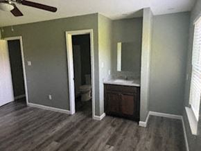 Prairie View apartment for rent - A bathroom with a wooden floor and a white vanity.