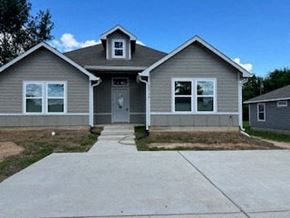 Prairie View apartment for rent - A grey house with a white door and windows.