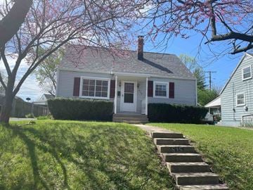 Dayton house for rent - a small white house with stairs in front of it