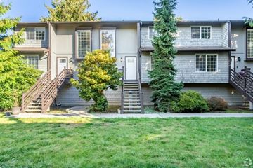 Mukilteo apartment for rent - the front of an apartment building with green grass and a sidewalk