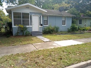 Jacksonville house for rent - a blue house with a sidewalk in front of it