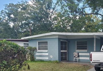 Jacksonville house for rent - a blue house with a wheelchair in front of it