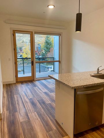 Jackson apartment for rent - a kitchen with a sink and a door to a balcony