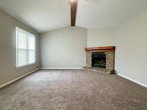 Pewee Valley house for rent - A room with a fireplace and carpeted floor.