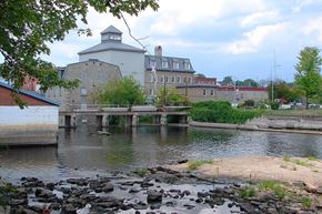 Smiths Falls apartment for rent - a bridge over a river with a building in the background
