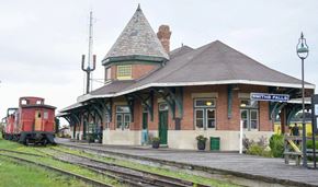 Smiths Falls apartment for rent - an old train station with a red train on the tracks