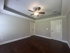 Baker house for rent - a empty living room with a ceiling fan