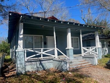 Jacksonville house for rent - A blue house with white railings and a red roof.