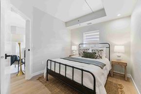 Winnipeg apartment for rent - A bedroom with a bed, nightstand, and lamp.