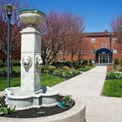 Philadelphia apartment for rent - a statue in the middle of a sidewalk in front of a building