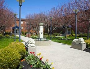 Philadelphia apartment for rent - a courtyard with a statue and flowers in front of a building