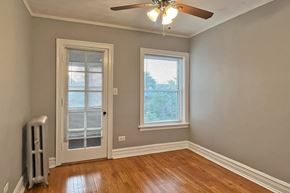 Chicago apartment for rent - A room with a window and a fan.