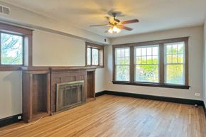 Oak Park apartment for rent - A room with a fireplace and a ceiling fan.
