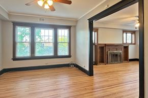 Oak Park apartment for rent - A room with a fireplace and a ceiling fan.