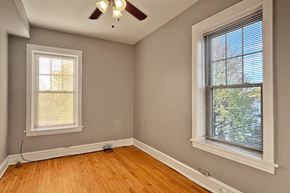 Oak Park apartment for rent - A room with a ceiling fan and two windows.