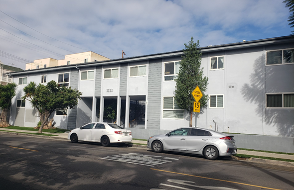 Los Angeles apartment for rent - a white building with two cars parked in front of it