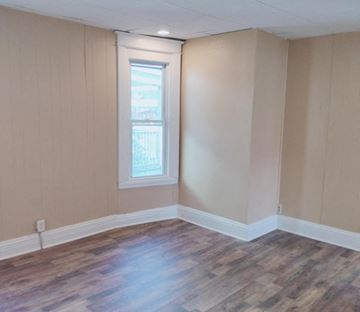 Hammond apartment for rent - an empty living room with wooden floors and a window