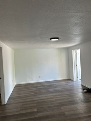 Fort Myers apartment for rent - A room with a light grey ceiling and a wooden floor.