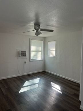 Fort Myers apartment for rent - A room with a ceiling fan and wooden flooring.