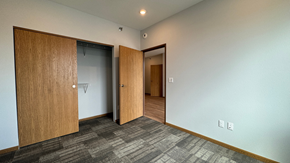 Fargo apartment for rent - a living room with two doors and a door to a closet