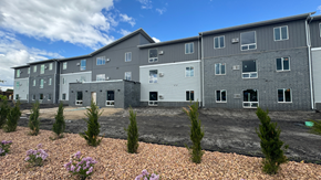 Fargo apartment for rent - an apartment building with gravel and plants in front of it