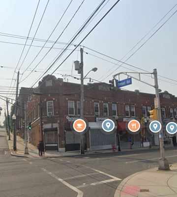 Orange apartment for rent - a city street with a brick building and street signs