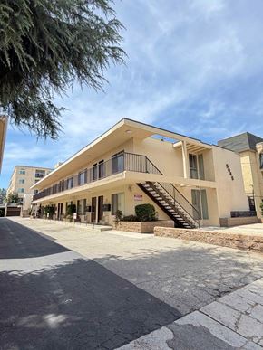 North Hollywood apartment for rent - A modern building with a flat roof and a balcony on the second floor.