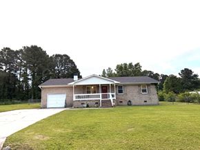 Jacksonville house for rent - a brick house with a yard and a white garage door
