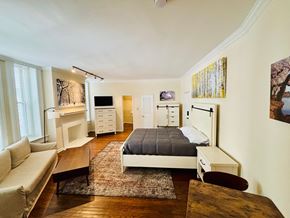 Washington apartment for rent - A bedroom with a bed, couch, and a TV.
