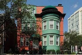 Washington apartment for rent - A green and red building with a tower.