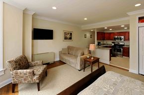 Washington apartment for rent - A living room with a couch, chair, and television.
