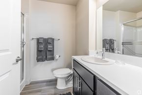 Troutdale apartment for rent - A bathroom with a toilet, sink, and towel rack.