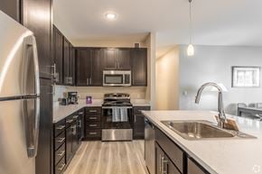 Troutdale apartment for rent - A modern kitchen with dark wood cabinets and stainless steel appliances.