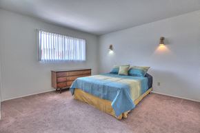 Albuquerque apartment for rent - A bedroom with a bed, dresser, and window.