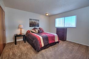 Albuquerque apartment for rent - A bedroom with a bed, nightstand, and window.
